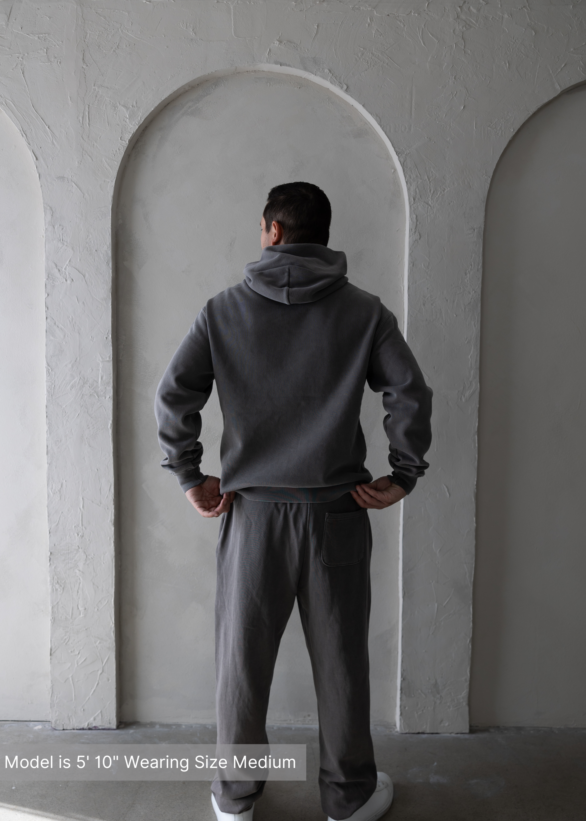 Back view of grey loungewear set worn with white sneakers, casual menswear look by stitched apparel branded as stchd.
